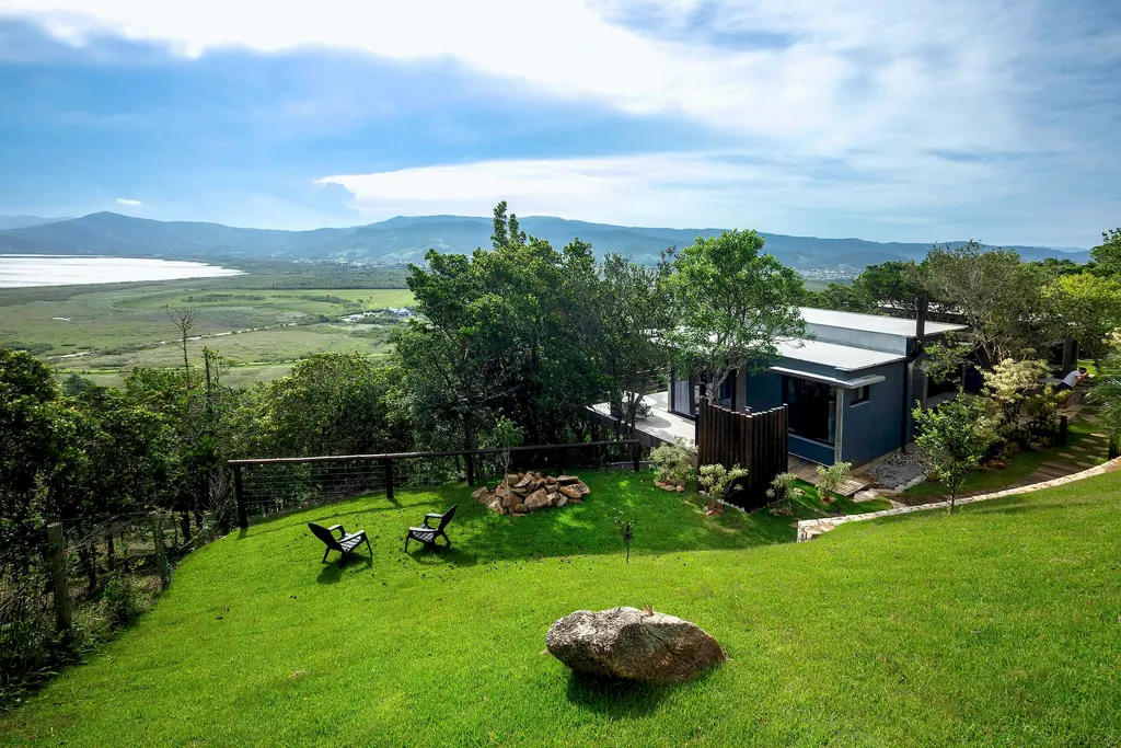 Aerial view of the lawn, houses and lagoon at Refúgio da Silveira
